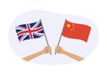 UK and China flags. Chinese and British national symbols. Hand holding waving flags. Vector illustration